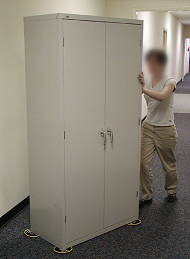 Girl using safety slides to push cabinet